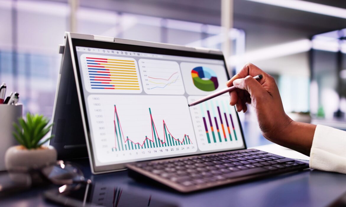 African,American,Woman,Analyzing,Financial,Data,On,Laptop,Screen,In