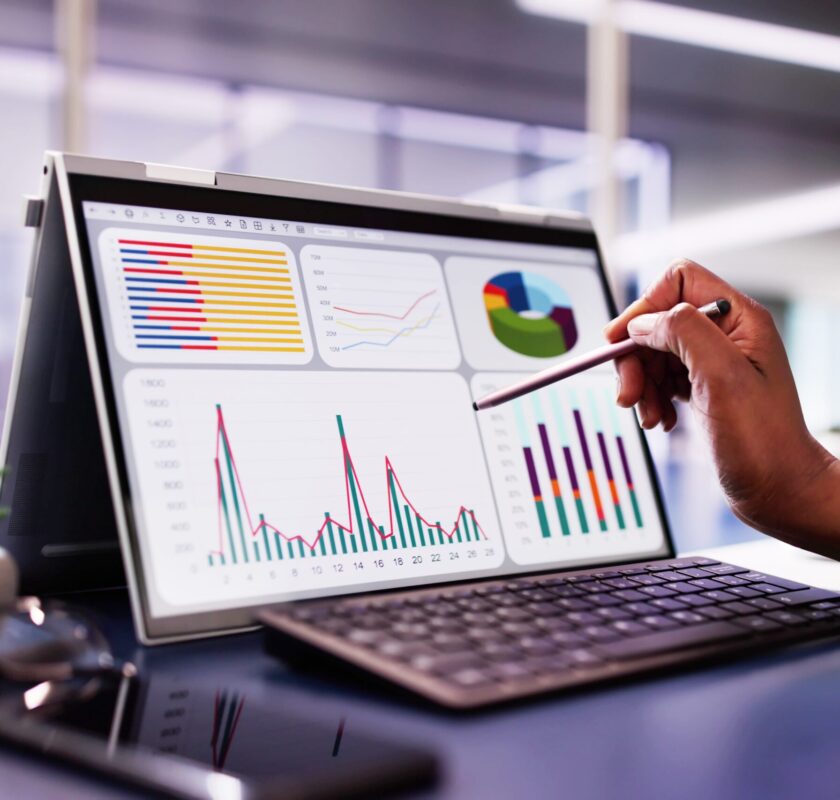 African,American,Woman,Analyzing,Financial,Data,On,Laptop,Screen,In